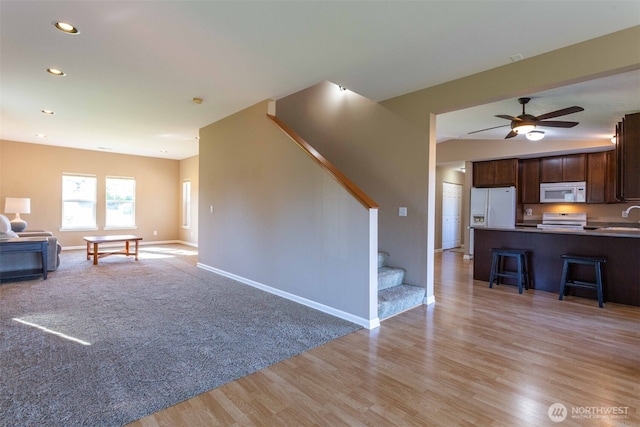 6130 Pacific Heights Dr, Ferndale, WA 98248 - living room with stairs, baseboards, light wood-style flooring, recessed lighting, and a ceiling fan