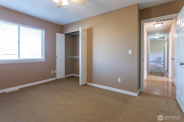 6130 Pacific Heights Dr, Ferndale, WA 98248 - unfurnished bedroom with carpet, baseboards, a closet, and ceiling fan