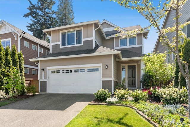 craftsman-style home featuring a garage, driveway, and board and batten siding