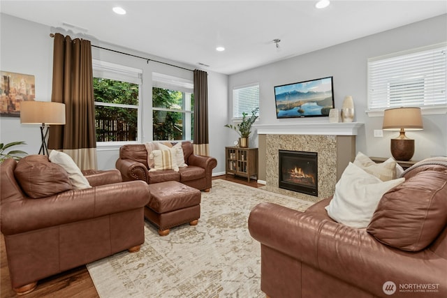 living area featuring wood finished floors, recessed lighting, and a fireplace