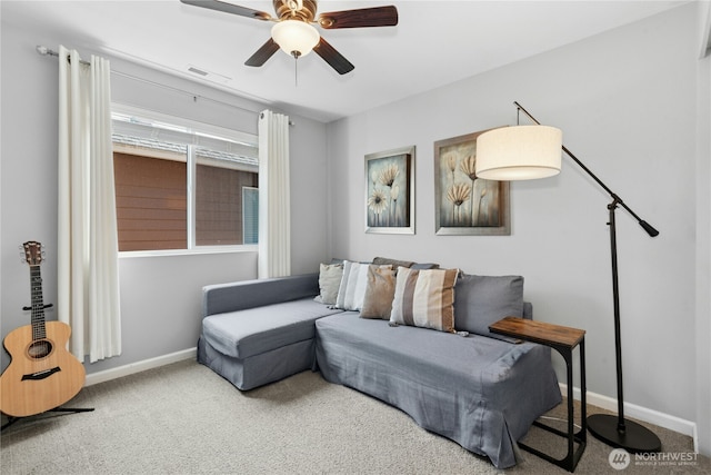 living room with ceiling fan, baseboards, and carpet flooring