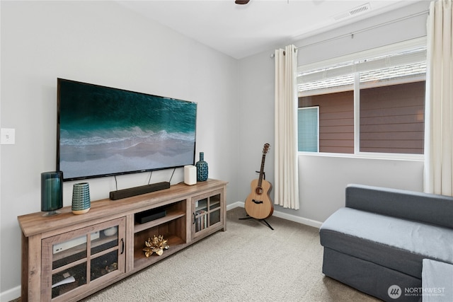 living area featuring carpet and baseboards