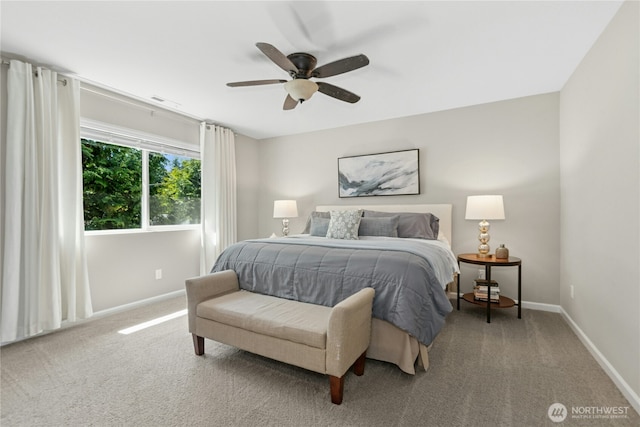 carpeted bedroom with baseboards and ceiling fan