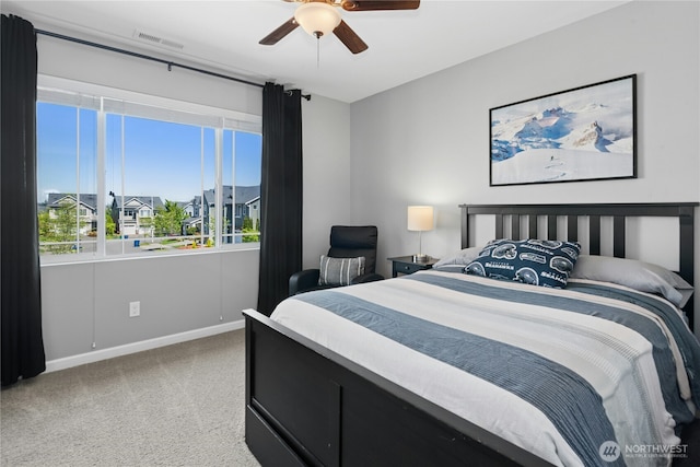 carpeted bedroom with baseboards and ceiling fan