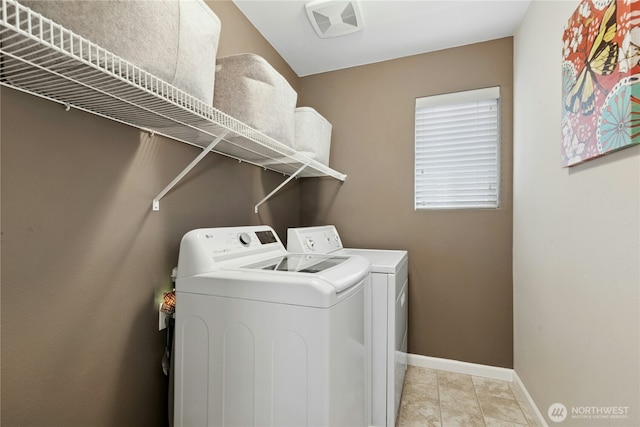 washroom with separate washer and dryer, baseboards, and light tile patterned floors