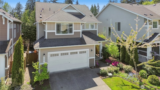 view of front of property featuring concrete driveway, roof with shingles, a garage, and board and batten siding