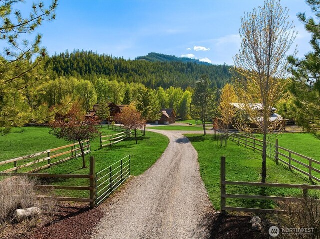 view of property's community with a view of trees and a view of rural / pastoral area