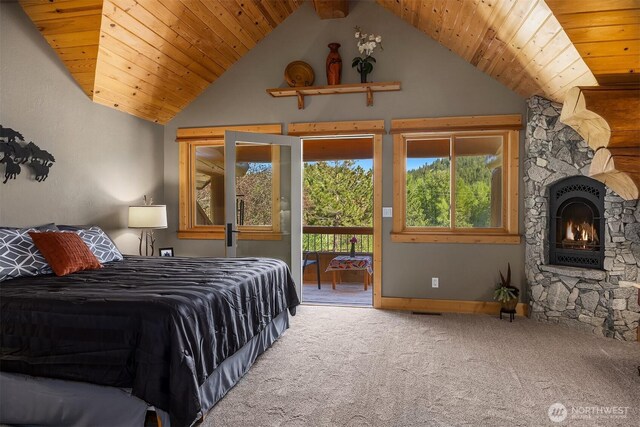 carpeted bedroom with access to exterior, lofted ceiling, a warm lit fireplace, wood ceiling, and baseboards
