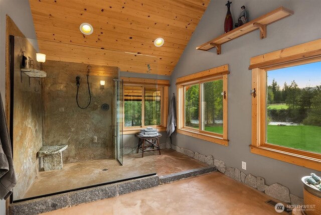 bathroom featuring lofted ceiling, healthy amount of natural light, wooden ceiling, a shower, and concrete floors