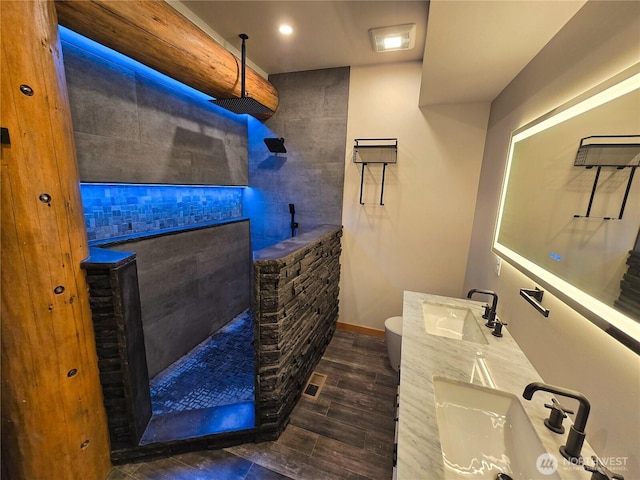 31314 555th Street Ct E, Ashford, WA 98304 - bathroom featuring walk in shower, wood finished floors, toilet, baseboards, and double vanity