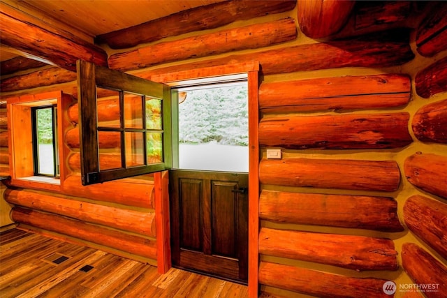 31314 555th Street Ct E, Ashford, WA 98304 - doorway to outside featuring healthy amount of natural light, log walls, wood finished floors, and beamed ceiling