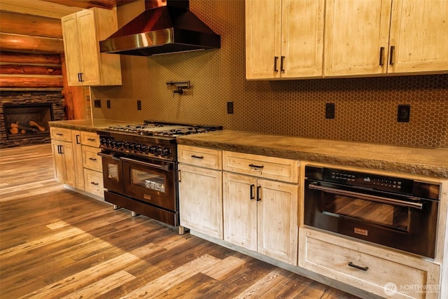 31314 555th Street Ct E, Ashford, WA 98304 - kitchen featuring island range hood, black appliances, dark wood finished floors, decorative backsplash, and dark countertops