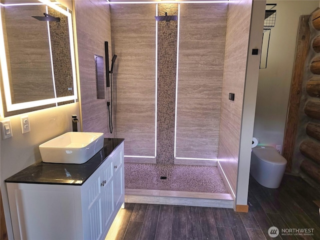 31314 555th Street Ct E, Ashford, WA 98304 - bathroom with toilet, tiled shower, vanity, and wood finished floors