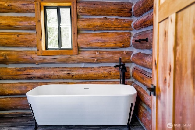31314 555th Street Ct E, Ashford, WA 98304 - bathroom with a freestanding bath, rustic walls, and wood finished floors