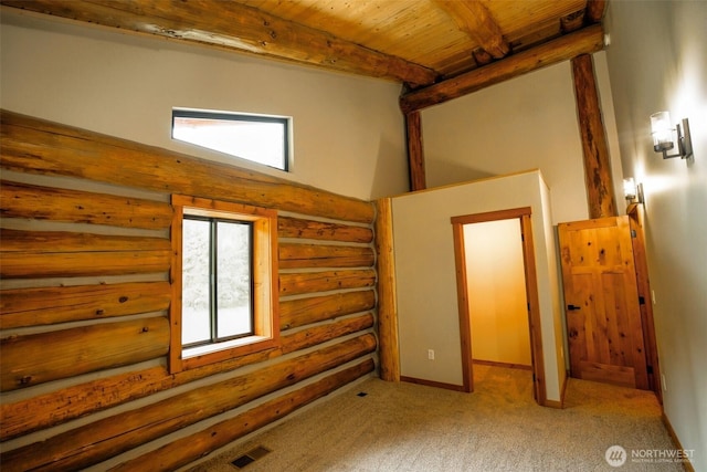 31314 555th Street Ct E, Ashford, WA 98304 - unfurnished bedroom featuring rustic walls, wooden ceiling with exposed beams, and carpet floors