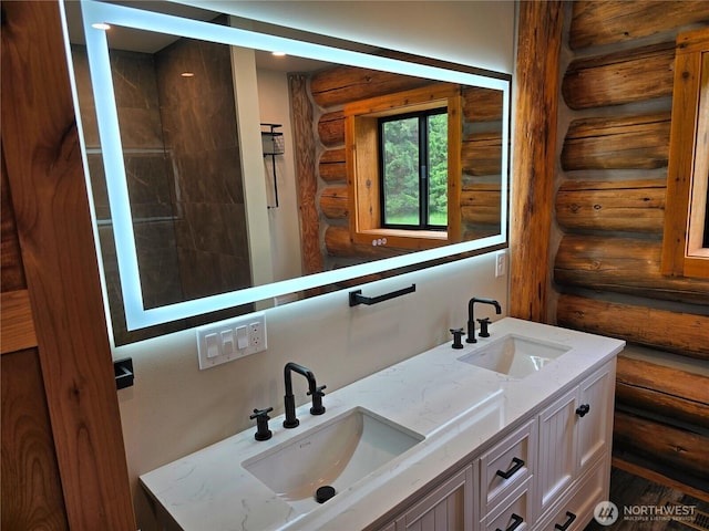 31314 555th Street Ct E, Ashford, WA 98304 - bathroom featuring log walls, double vanity, and wood finished floors