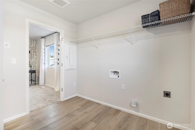 laundry area with light wood finished floors, electric dryer hookup, washer hookup, baseboards, and hookup for a gas dryer