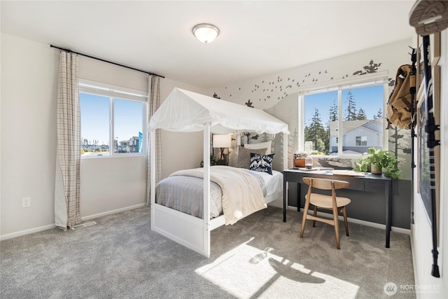 carpeted bedroom featuring baseboards