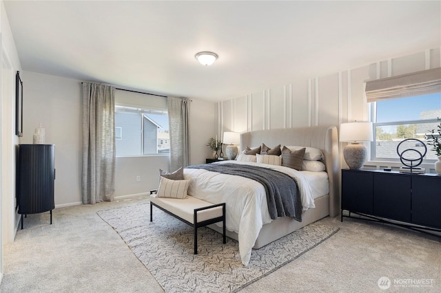 bedroom featuring light carpet and baseboards