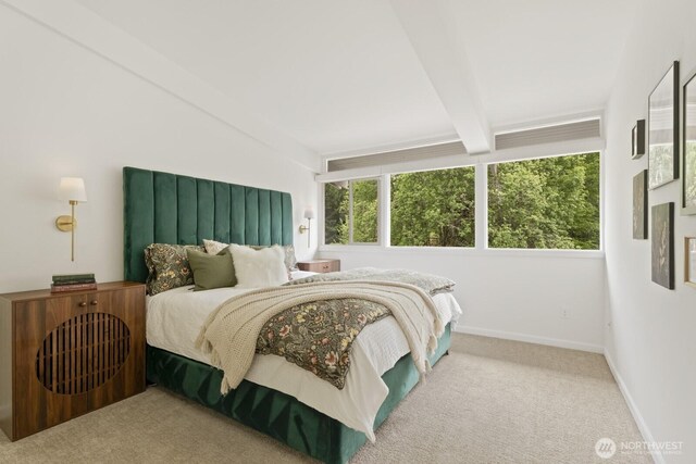 carpeted bedroom featuring beamed ceiling and baseboards