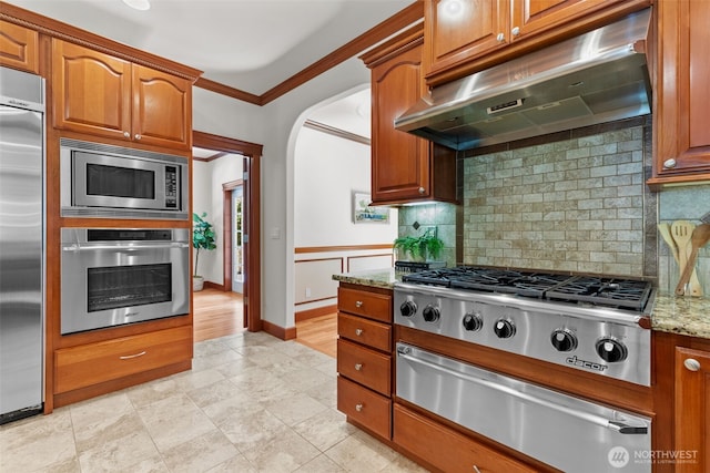 13514 95th Ave NE, Arlington, WA 98223 - kitchen featuring built in appliances, under cabinet range hood, a warming drawer, ornamental molding, and light stone countertops
