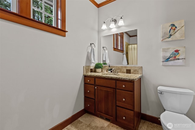 13514 95th Ave NE, Arlington, WA 98223 - full bathroom with baseboards, toilet, vanity, crown molding, and backsplash