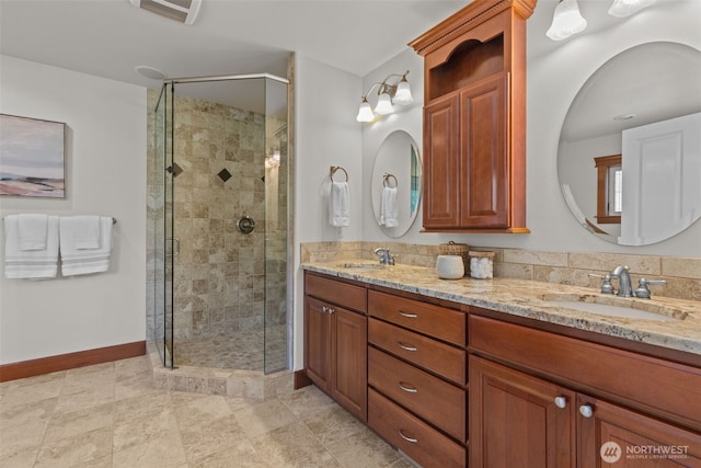 13514 95th Ave NE, Arlington, WA 98223 - bathroom featuring a stall shower, baseboards, and double vanity