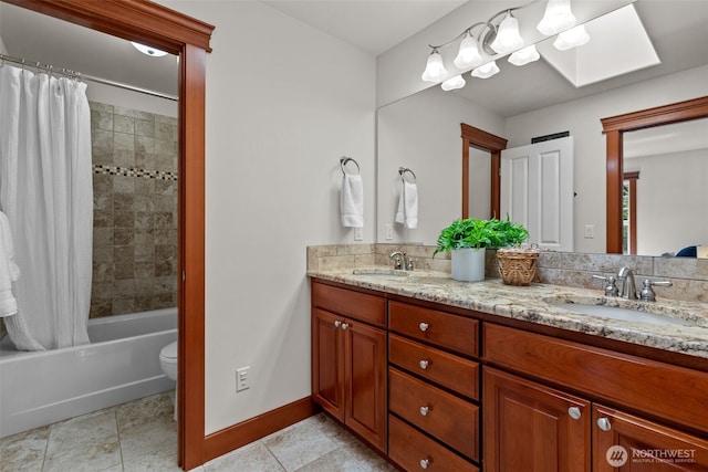 13514 95th Ave NE, Arlington, WA 98223 - full bathroom with double vanity, a skylight, shower / bath combo, baseboards, and toilet