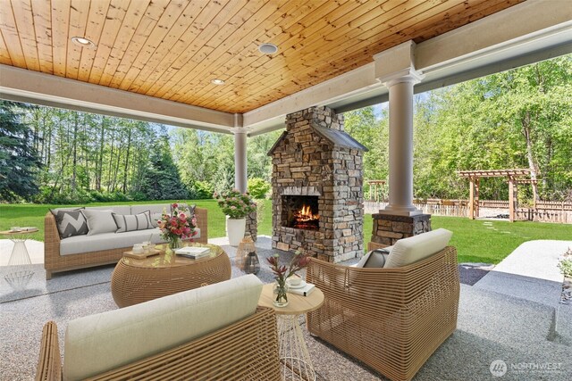 13514 95th Ave NE, Arlington, WA 98223 - view of patio / terrace with an outdoor living space with a fireplace and view of wooded area