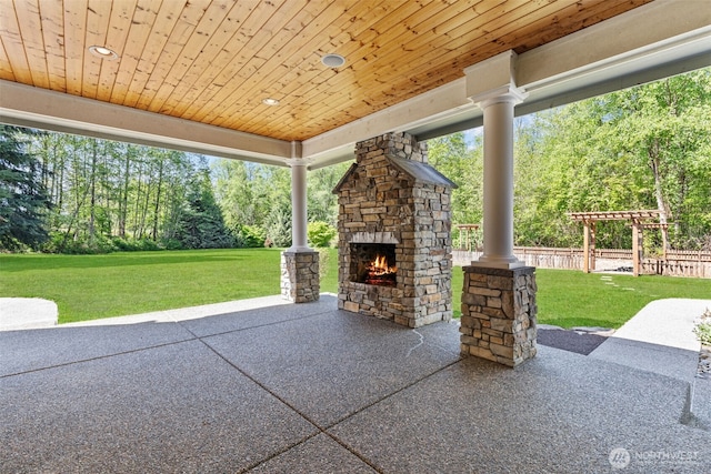 13514 95th Ave NE, Arlington, WA 98223 - view of patio with an outdoor stone fireplace and view of scattered trees