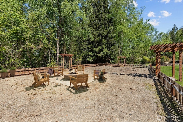 13514 95th Ave NE, Arlington, WA 98223 - view of yard with an outdoor fire pit, fence, and a pergola