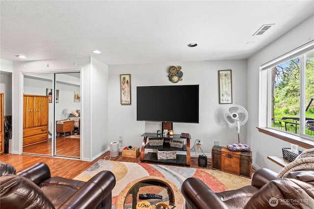 2219 W Pioneer Ave, Puyallup, WA 98371 - living area with wood finished floors, baseboards, and recessed lighting