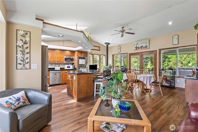 2219 W Pioneer Ave, Puyallup, WA 98371 - living room with ceiling fan, plenty of natural light, light wood-type flooring, recessed lighting, and vaulted ceiling