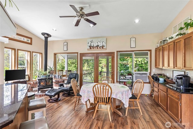 2219 W Pioneer Ave, Puyallup, WA 98371 - dining area featuring a wood stove, dark wood finished floors, a ceiling fan, lofted ceiling, and recessed lighting