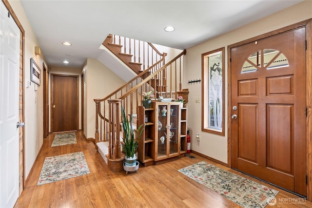 2219 W Pioneer Ave, Puyallup, WA 98371 - entrance foyer featuring wood finished floors, stairway, baseboards, and recessed lighting