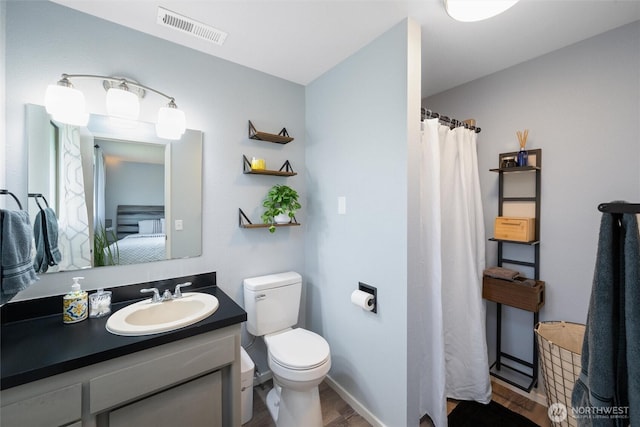 full bath featuring toilet, wood finished floors, vanity, ensuite bathroom, and a shower with curtain
