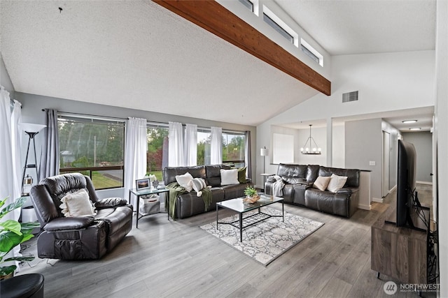 living area with wood finished floors and a chandelier