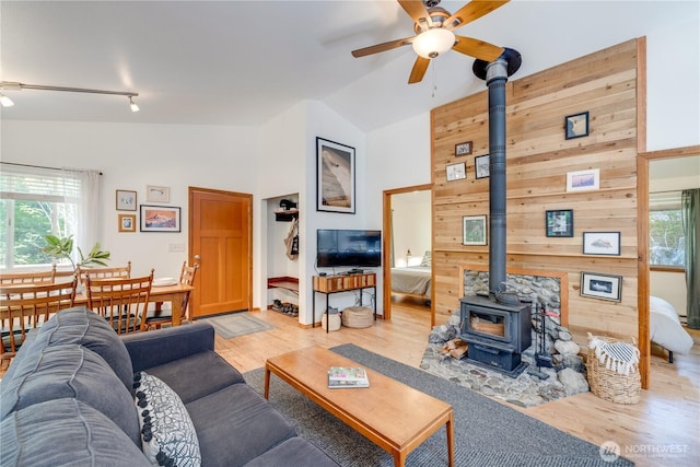 7537 Canyon View Dr, Glacier, WA 98244 - living area with a wood stove, ceiling fan, healthy amount of natural light, track lighting, and high vaulted ceiling