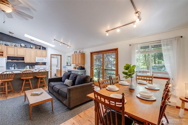 7537 Canyon View Dr, Glacier, WA 98244 - living area featuring rail lighting, light wood-type flooring, a ceiling fan, vaulted ceiling, and a baseboard radiator