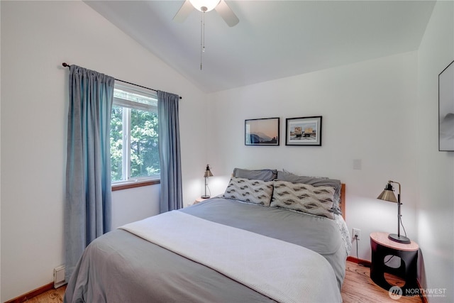 7537 Canyon View Dr, Glacier, WA 98244 - bedroom with vaulted ceiling, light wood-style floors, baseboards, a ceiling fan, and baseboard heating