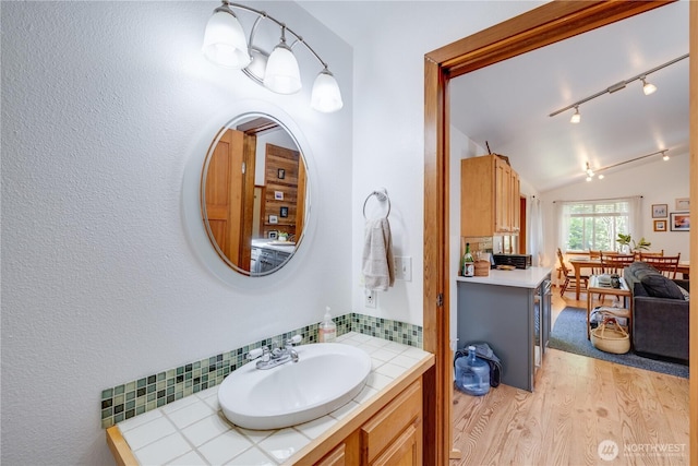 7537 Canyon View Dr, Glacier, WA 98244 - bathroom featuring wood finished floors, vaulted ceiling, and vanity