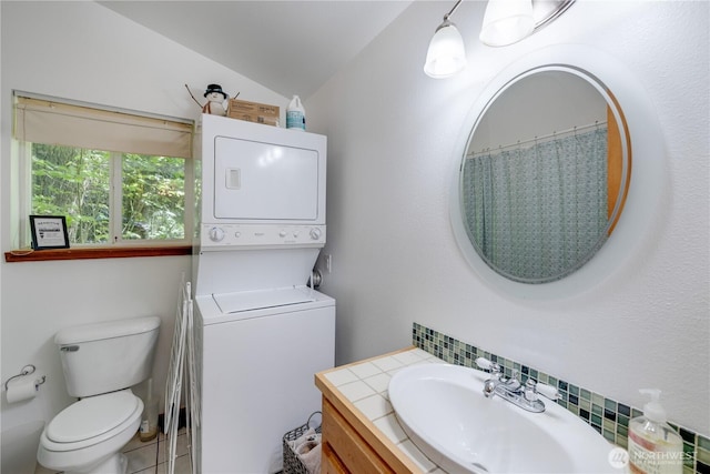 7537 Canyon View Dr, Glacier, WA 98244 - bathroom featuring stacked washer / drying machine, toilet, lofted ceiling, and vanity