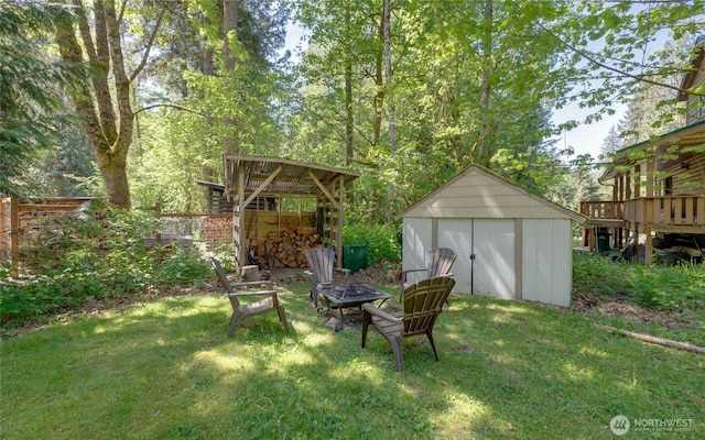 7537 Canyon View Dr, Glacier, WA 98244 - view of green lawn featuring a shed, an outbuilding, and a fire pit