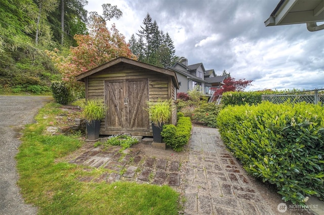 view of shed with fence