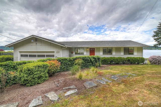 single story home featuring a garage and a front lawn