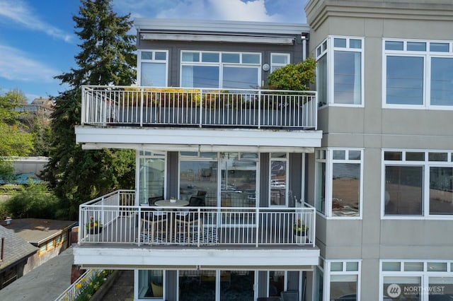 rear view of property with a balcony