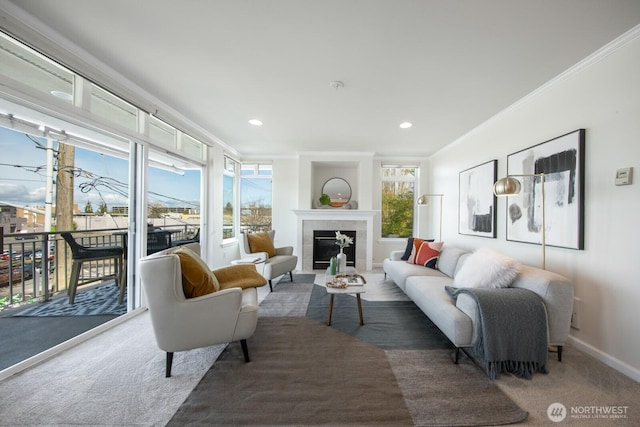 living room with ornamental molding, baseboards, a fireplace, carpet, and recessed lighting