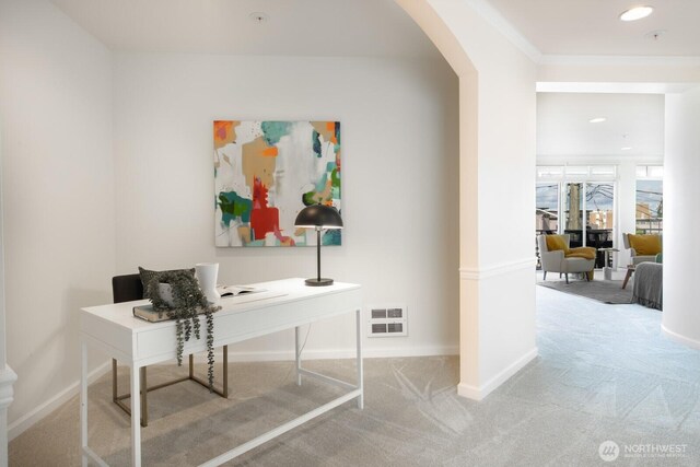 carpeted office with arched walkways, baseboards, and recessed lighting