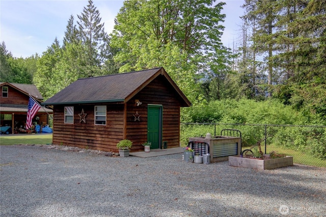 42809 Rivers Edge Ct, Concrete, WA 98237 - view of front of house featuring an outdoor structure, fence, and a shingled roof