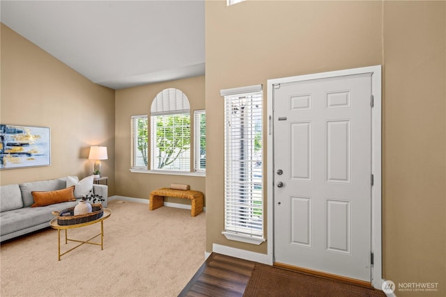 foyer featuring baseboards and wood finished floors